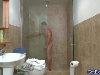 Exceptional muscled bloke jerking under shower